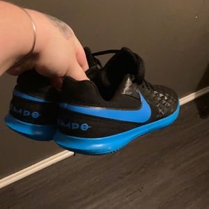 Black and electric blue Nike Tiempo sneakers used for sale…